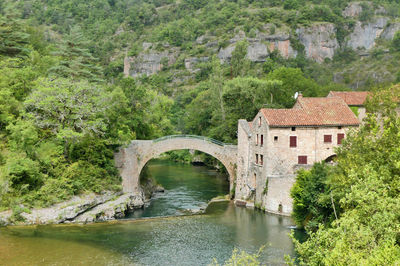 Bridge over river amidst buildings