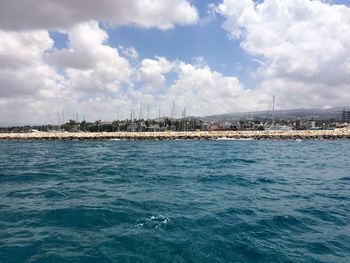 View of harbor against cloudy sky
