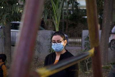 Portrait of boy standing by plants