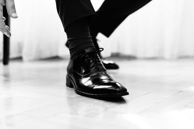 Low section of person standing on tiled floor