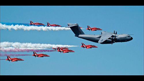 Low angle view of airshow against clear sky