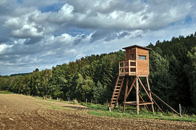 Built structure on field against sky