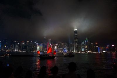 Illuminated city at waterfront at night