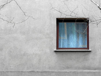 Old square window on concrete wall