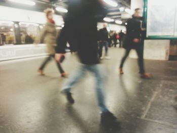 Blurred motion of people walking on road