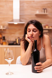 Young woman drinking wine in cafe