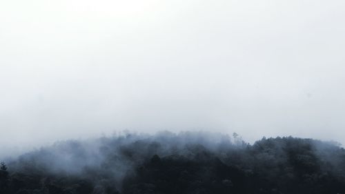 Scenic view of mountains in foggy weather