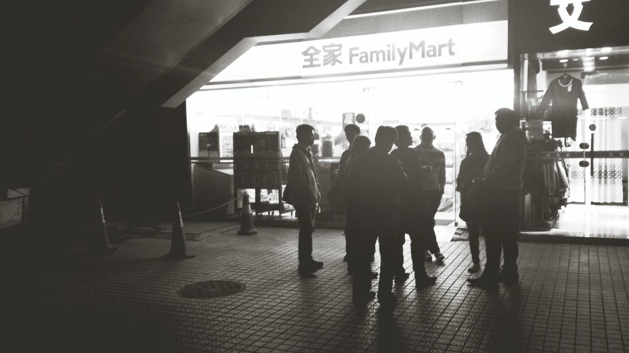 men, walking, person, lifestyles, text, architecture, indoors, built structure, city life, western script, transportation, communication, city, railroad station, leisure activity, medium group of people, full length, street, large group of people