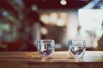 Close-up of two glasses on table