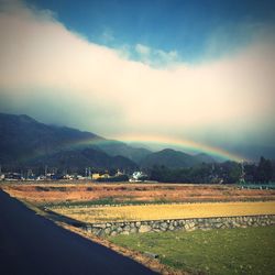 Scenic view of landscape against cloudy sky