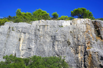 Low angle view of rock formation against sky