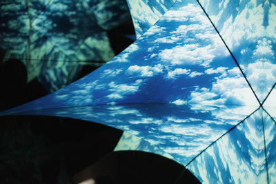 Low angle view of blue sky seen through glass