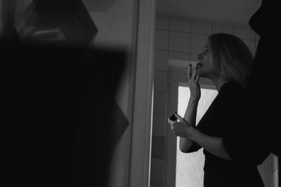 Side view of woman using mobile phone