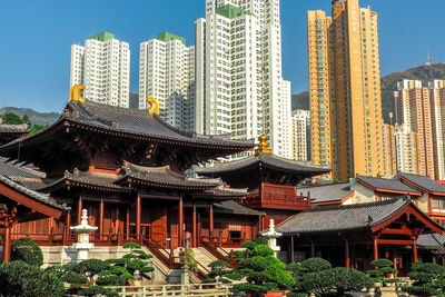 Panoramic view of buildings in city against sky