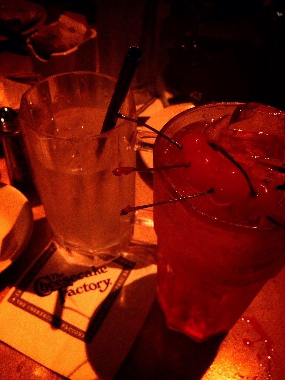 food and drink, drink, indoors, freshness, red, table, refreshment, close-up, still life, drinking glass, drinking straw, glass - material, alcohol, focus on foreground, high angle view, cocktail, no people, healthy eating, restaurant, food