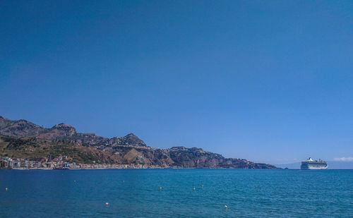 Scenic view of sea against clear blue sky