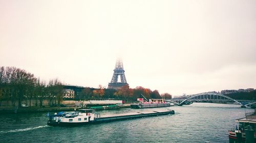 Boats in river with buildings in background