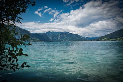 Scenic view of sea and mountains against sky