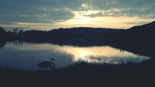 Scenic view of lake at sunset