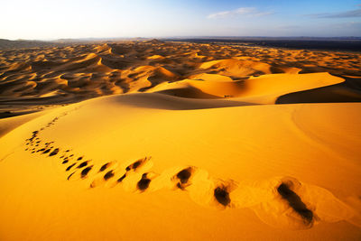 Footprints on sand dunes at erg chebbi desert