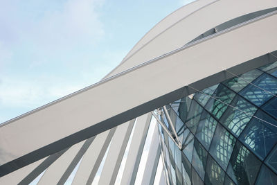 Low angle view of glass building against sky