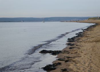 Scenic view of beach against clear sky