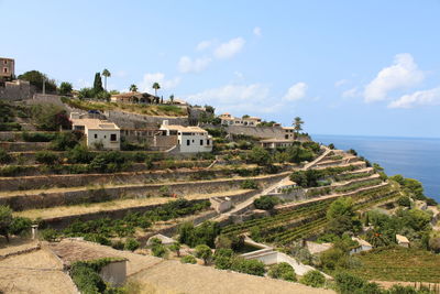 Scenic view of sea and buildings against sky