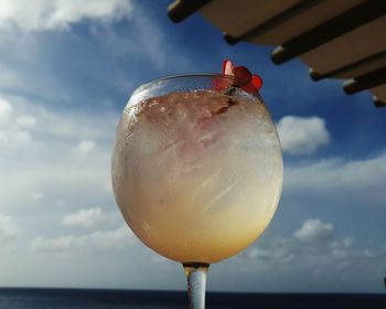 Close-up of  drink against sea and caribbean sky