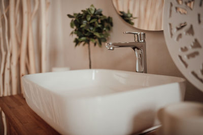 Luxury interior of big bathroom at modern african style with oval bathtub in natural lighting