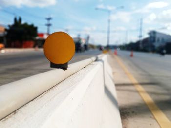Close-up of yellow railroad track on road