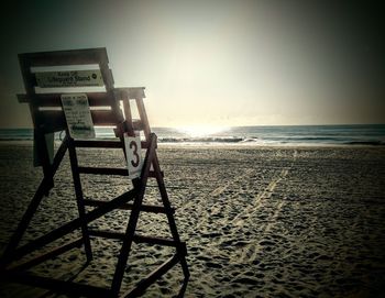 Lifeguard hut on beach against sky