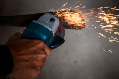 Cropped hand welding in workshop