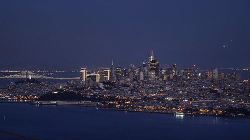 Illuminated city at waterfront