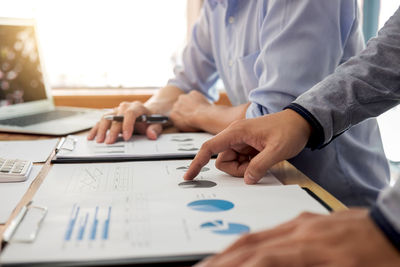 Close-up of business colleagues working in office