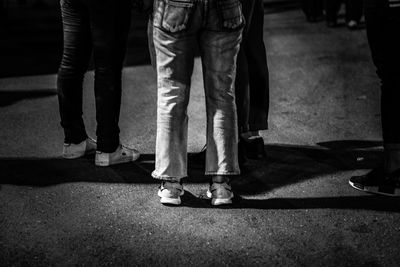 Low section of people standing on street