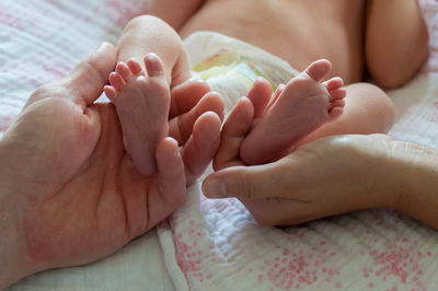 Close-up of hands holding baby feet