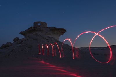 Light painting against sky at night