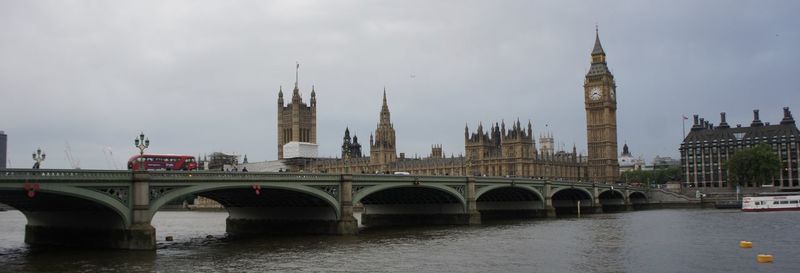 Bridge over river in city against sky