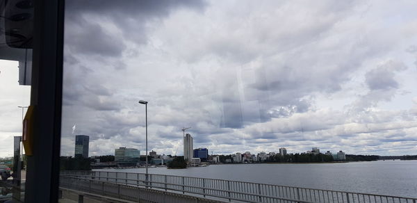 Buildings against cloudy sky