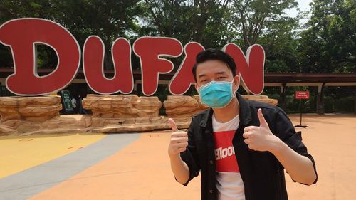 Full length of boy standing by text