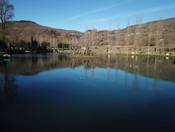 Scenic view of lake against clear blue sky