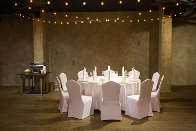 Chairs arranged at table during wedding ceremony