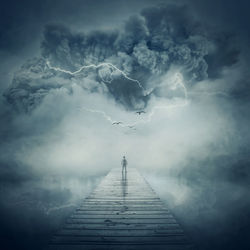 Digital composite image of man standing on pier over sea during storm