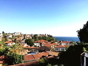 Antalya cityscape by sea against clear blue sky