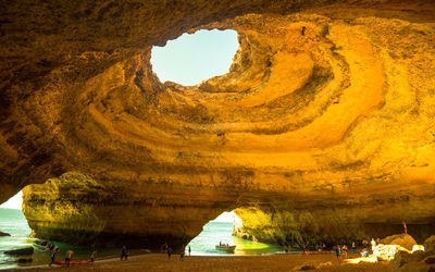 Scenic view of sea seen through cave