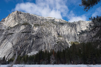 Low angle view of rocky mountain against sky