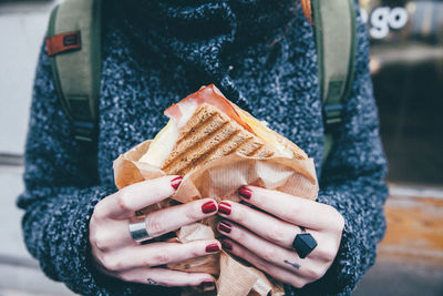 Close-up of hands holding sandwich