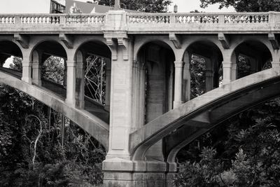 Low angle view of arch bridge against building