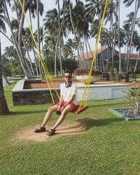 Portrait of boy on swing at park