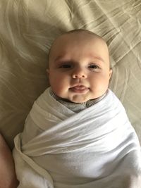 Directly above shot of cute baby girl on bed